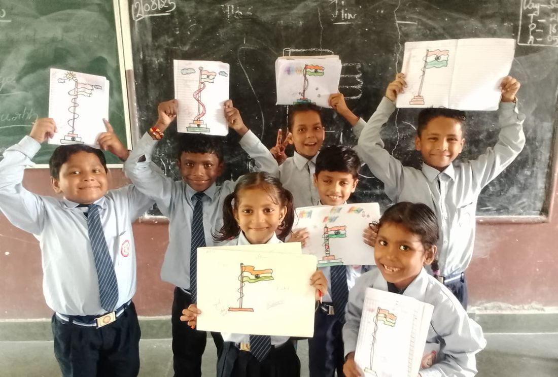 Students proudly showing their tricolour drawings