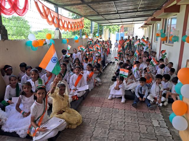 Students waving the tricolour at the celebration